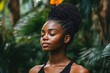 © Lubos Chlubny - Young woman meditating with closed eyes in lush tropical garden