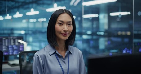 Poster - Portrait of a Data Center Administrator Working Behind a Desk, Optimizing Server Configurations on a Desktop Computer. Beautiful Female Specialists Looking at Camera and Smiling. Arc Footage
