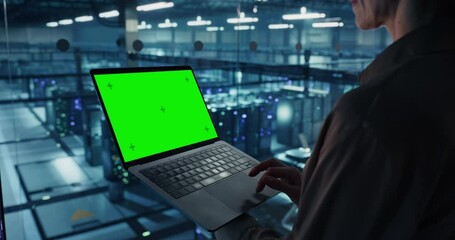Poster - Female Cybersecurity Expert Standing in Office, Working on Her Laptop Computer with Green Screen Mock Up Template on Display in a Modern Facility of a Data Center with Server Racks