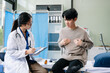 © Nuttapong punna - Doctor examining patient with symptoms in a clinic. Medical consultation and healthcare interaction.