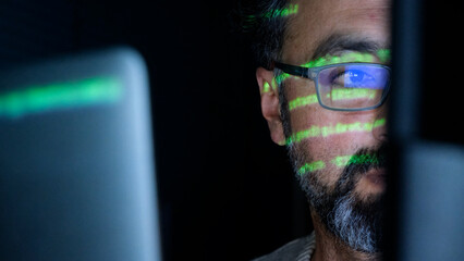 focused coder analyzes code on computer screen in dark environment - cyber security, cyber attack, p