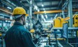 © jambulart - Factory worker in safety gear observing a machine.