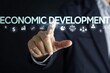 © Wan - Businessman interacting with economic development graphics.