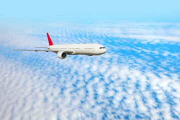 White passenger airplane flying in the sky amazing clouds in the background - Travel by air transport