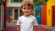 © Korawan - A young boy wearing a white shirt is smiling