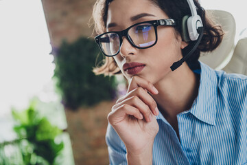 Photo of thoughtful lady specialist dressed shirt eyewear earphones hand arm chin indoors workstation workshop