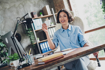 Photo of positive excited lady specialist dressed shirt having pause enjoying coffee indoors workstation workshop