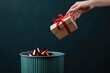 © deny - Hand throwing gift box into trash bin or waste bucket. Rejected bad gift concept