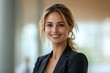 © Imagentive - Smiling Blonde Businesswoman in Black Blazer Studio Portrait