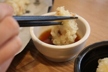 Fried food dipped in soy sauce