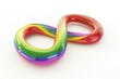 © vefimov - Flexible, twisted rainbow rubber band looped in an abstract design.