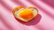 © Your Hand Please - heart-shaped fried egg sits on a colorful backdrop, symbolizing love and warmth. This playful, cheerful image evokes feelings of joy, comfort, and a fresh start to the day