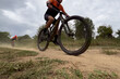 © Real Sports Photos - athlete riding mountain bike on dusty trail in cross country race