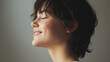 © SB4 GM - Side profile of a person smiling slightly, captured in natural light against a neutral background for a soft effect