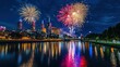 © KEOCHAN - A vibrant display of fireworks exploding in the night sky over a city skyline, with reflections shimmering on the water