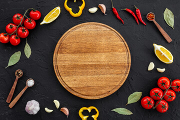 Wall Mural - Wooden cutting board and vegetables with spices, top view. Cooking layout