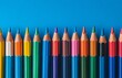 © olegganko - Colorful arrangement of sharpened colored pencils on a bright blue background