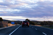 © Austockphoto - Car on road trip adventure at dusk driving on rural road near Goulburn