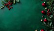 © Wimon - Top-down view of Christmas greenery and red berries on an emerald green background, with a sprinkle of tiny gold ornaments for a festive touch.