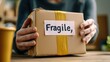 © Smoky - Mother carefully packing fragile boxes for a safe move in a clean setting
