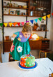 © Melissa Milis Photography/Stocksy - 3 year old blowing out candles for her birthday