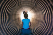 © Anya Brewley Schultheiss/Stocksy - Kindergarten aged child sliding down a metal tube