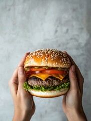 Poster - Two hands hold a hearty burger topped with lettuce, cheese, tomato, and pickles, highlighting a tempting culinary delight. Generative AI