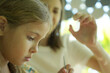 © romaset - Teacher in workshop teched two girls how to assemble a thermo mosaic