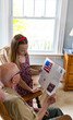 © Raymond Forbes LLC/Stocksy - Young Girl hands card portrait thanking veteran tribute vets day
