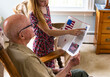 © Raymond Forbes LLC/Stocksy - Young Girl hands card portrait thanks veteran day