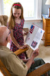 © Raymond Forbes LLC/Stocksy - Young Girl hands card portrait thanking veteran tribute