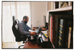 © Olga Moreira/Stocksy - Man working on computer at home