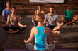 © peopleimages.com - Lotus, meditation or instructor with people in yoga class for chakra energy, therapy and inner peace in studio. Group, wellness and zen yogi in apartment for spiritual healing or calm mindfulness