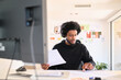 © Guille Faingold/Stocksy - A focused businessman reviewing documents in a modern office