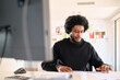 © Guille Faingold/Stocksy - Businessman reviewing documents at a modern desk