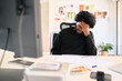 © Guille Faingold/Stocksy - Businessman feeling stressed while working at a desk in a home office