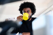 © Guille Faingold/Stocksy - BusinessMan enjoying a yellow mug of coffee at a desk