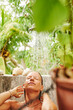 © Ivan Gener/Stocksy - Young female having a shower outdoors