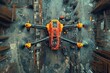 © KRIS - An orange and yellow drone with four propellers is positioned on a construction site with metal beams and construction equipment.