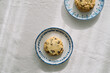 © Adrian Cotiga/Stocksy - Single cookie on decorative plate with blue border