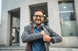 © Miljan Živković - Portrait of handsome businessman puts the phone in pocket of his suit