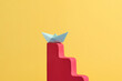 © Marc Tran/Stocksy - Paper ship for shortcut way of success in business growth concept.