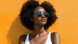© DSimage - Woman wearing white tank top and sunglasses, enjoying sunny day outdoors, casual and relaxed appearance.