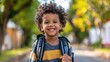 © Viktoriia - A happy little African American boy with a school backpack beams with excitement, ready for his day of learning.