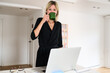 © Guille Faingold/Stocksy - Woman sips coffee at her laptop
