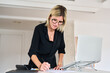 © Guille Faingold/Stocksy - Woman working at desk in modern office space