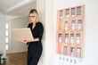© Guille Faingold/Stocksy - Woman working on laptop in modern office setting