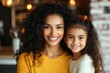 © Odin AI - A beautiful joyful moment captured in a warm kitchen featuring a mother and daughter with curly hair, wearing yellow and white outfits and smiling brightly.