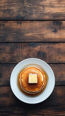 Wall Mural - Pancakes on a wooden table, drizzled with syrup and topped with butter