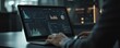 © tydeline - Person Analyzing Data on Laptop in Modern Office at Night with Advanced Technology Interfaces